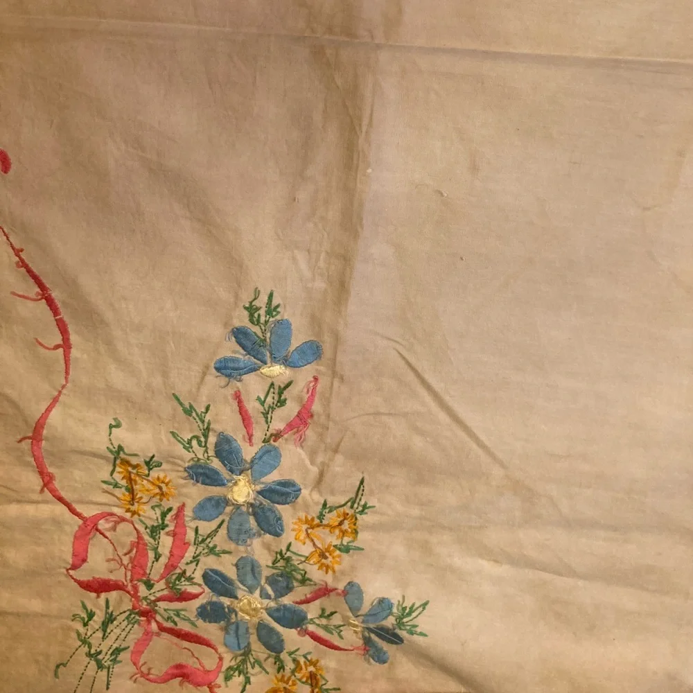 Vintage embroidery muslin, three corners begun, one ink outline blue pink red